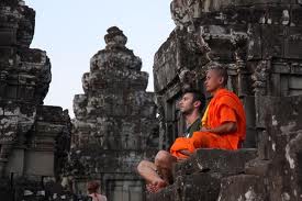 monk teaching westerner to meditate